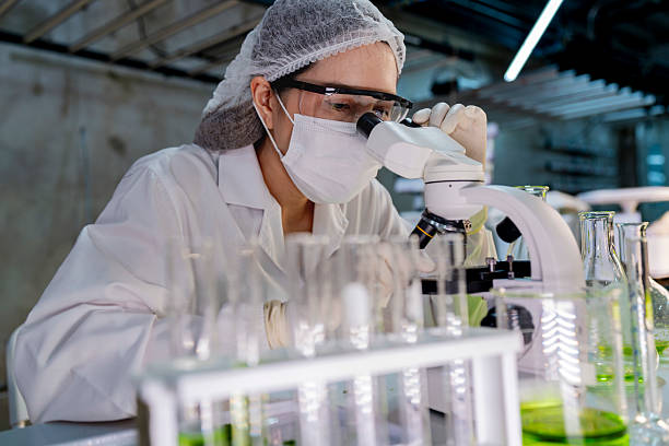 istock A researcher in a sterile lab conducts a scientific experiment using a microscope and test tubes. Cutting edge biotechnology and chemistry help develop breakthroughs in medicine and healthcare. 2217213902