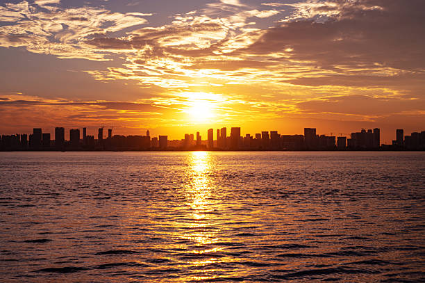 istock Dramatic sky and clouds with modern urban skyline during sunset defocused blurred abstract background 2217213974