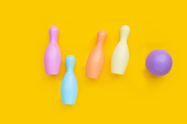 istock Colorful plastic bowling toy on yellow background. 2217222742