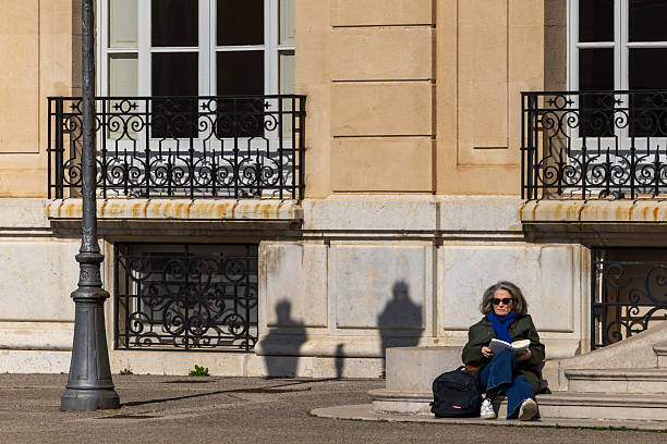 Paris, France - May 11, 2025:  A man sunbathes in the Tuileries Garden on the  Right Bank of the Seine River.