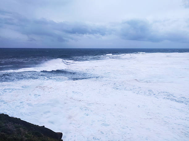 istock Stormy seascape featuring powerful waves crashing under a moody, overcast sky. Evokes feelings of strength, natures power, and resilience. Perfect for conveying drama or challenges. 2217224608
