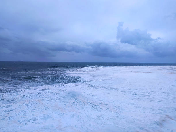 istock Dramatic seascape featuring powerful waves crashing under a stormy sky. Evokes themes of natures force, resilience, and the beauty of the ocean. 2217224652
