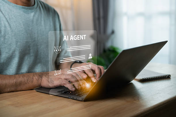 istock Man Using Laptop with AI Agent Interface for Digital Interaction and Automation in Home Workspace with Soft Natural Lighting and Minimalist Design 2217225867