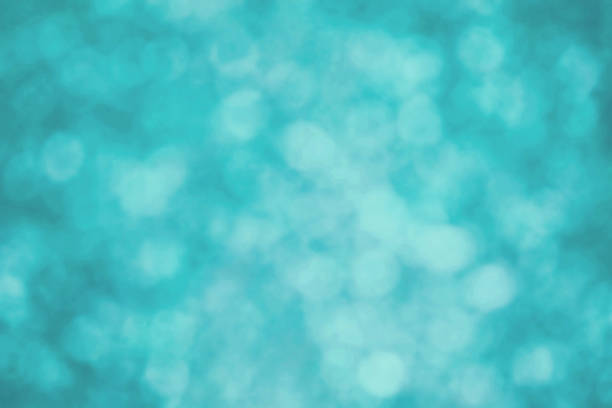 istock Turquoise blue abstract texture with glittering and overlapping bubble-like bokeh. 2217226176