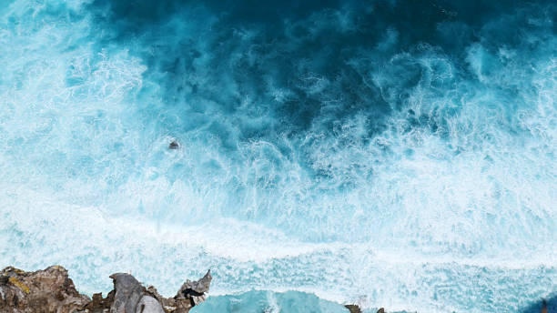 istock Turquoise ocean sea water white wave pattern splashing deep blue sea. Seascape dark ocean background wave splash on rock. Tropical sea beach in summer seaside outdoor. Water Surface blue wave pattern 2217228081