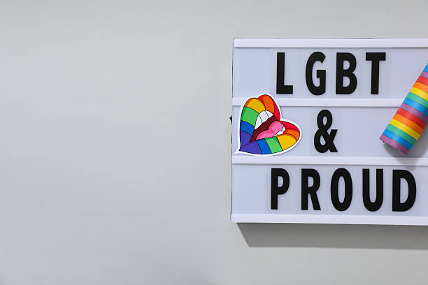 istock LGBT parade concept, inscription on white board. 2217230024