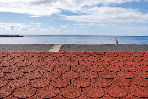 istock Minimal beach scene with rooftop foreground and early summer seaside calm 2217236107