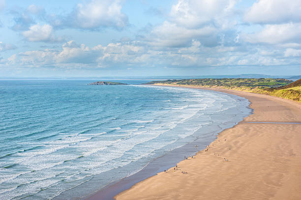 istock Tranquil Coastal Beach and Ocean Waves under a Blue Sky 2217241384