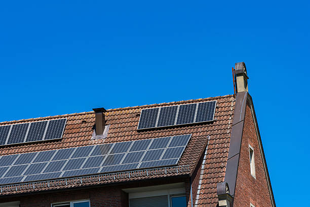 istock Solar panels installed on a residential rooftop under clear blue skies 2217241815