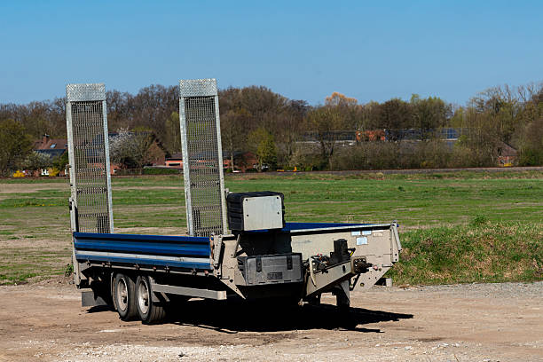 istock Trailer parked in open field under clear blue sky 2217242042