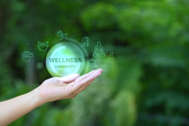 istock Open hand holding virtual icons representing longevity, health, and holistic wellbeing 2217245523