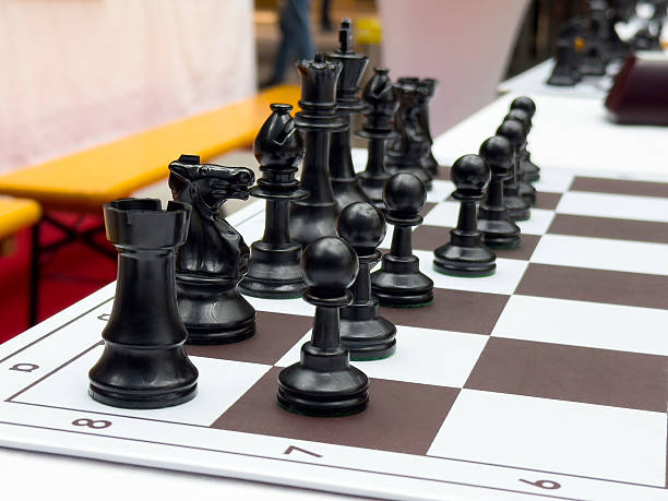istock Black chess pieces arranged on board for intense strategic gameplay 2217246275