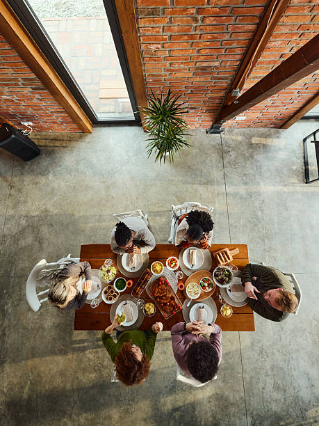 istock Above view of young friends having lunch at dining table. 2217250435