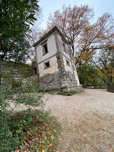 istock Architectural oddity leaning dramatically within Bomarzo's Park of Monsters, surrounded by vibrant fall woodland landscape 2217254266