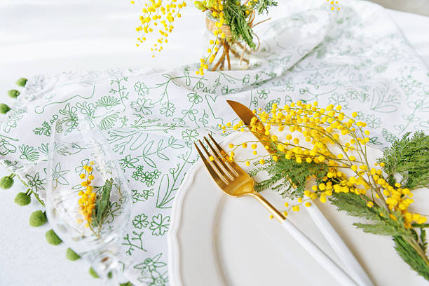 istock Elegant spring dining table with mimosa flowers and champagne glass 2217254688