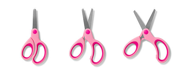 Pink children's scissors, closed open and wide open, isolated on a white background. High resolution.