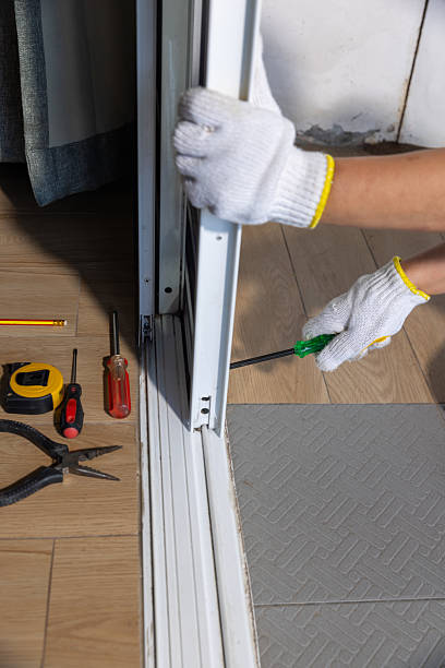 istock Worker fixing derailed roller of sliding door. Replace Sliding Glass Door Rollers concept 2217256107