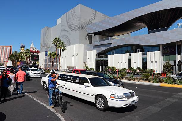 White limo drives in front of The Linq Hotel at the Strip in Las Vegas. 15 of 25 largest hotels in the world are located at the strip with more than 60 thousand rooms.