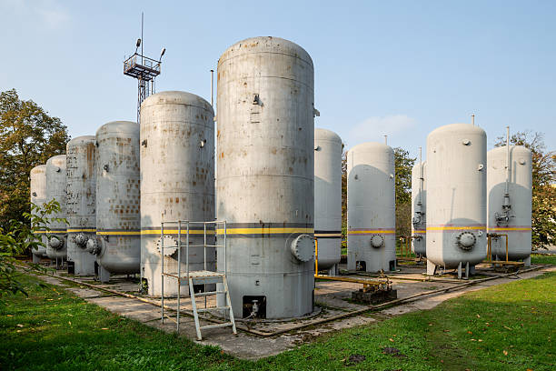 Large industrial tanks used for storing both carbon dioxide and hydrogen at a facility. Connected pipes and valves ensure controlled gas distribution and safe storage in an industrial setting