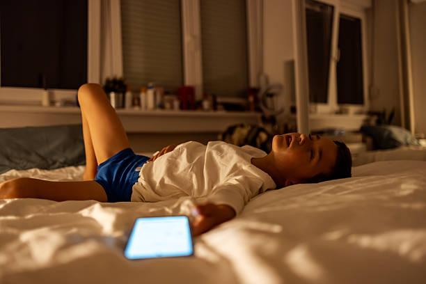 istock Young Boy Asleep at Night With Phone Lying Next to Him 2217270289