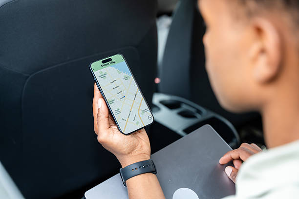 istock businessman using gps navigation on smartphone while sitting in car 2217271742