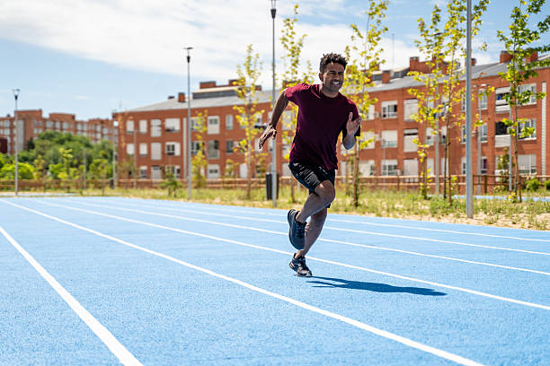 istock Adult Man Sprinting on Blue Track 2217272028