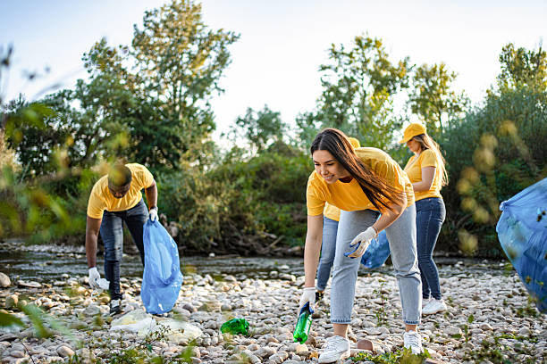 istock Volunteers cleaning plastic waste from polluted river 2217274470