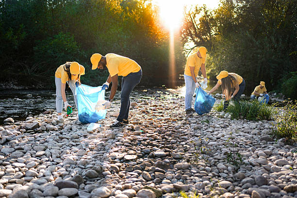 istock Volunteers cleaning plastic waste from polluted river 2217274545