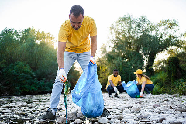 istock Volunteers cleaning river from plastic waste pollution in nature 2217274878