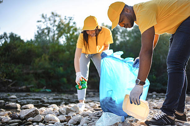 istock Volunteers collecting plastic waste on river coast 2217274974