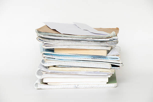 istock A stack of old notebooks, notepads and books on a white background, a symbol of study, education and work 2217276327