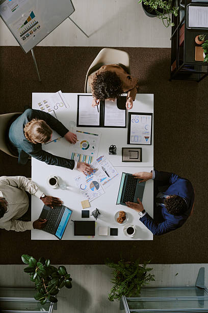 istock Collaborative Team Meeting Reviewing Financial Reports 2217277001