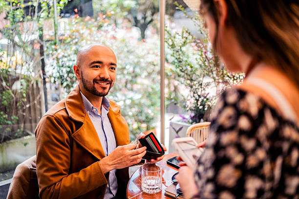 istock Mid adult man paying the bill on a restaurant 2217277787