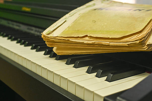 A side view of a wooden piano with an open music book resting on its stand. This image captures the timeless elegance and creative atmosphere of musical expression and practice.