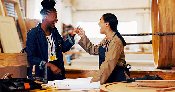istock Fist bump, women and carpenter with teamwork in workshop for furniture, process or manufacturing. Happy, partnership and female woodworker with client in warehouse for timber material production. 2217280163