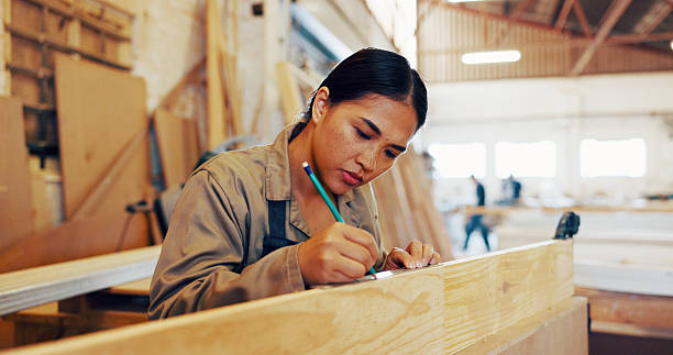istock Carpentry, drawing and industry with woman in workshop for manufacturing or production process. Creative, design and marking with carpenter in woodworking studio for craftsmanship or manual labor 2217280166