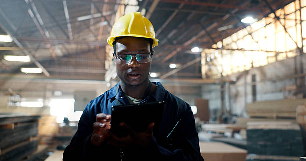 istock Tablet, typing and woodwork with black man in warehouse for carpenter, digital checklist and search. Inspection, supplier inventory and furniture with person in factory for online distribution 2217280298