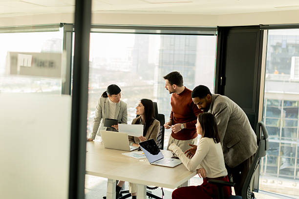istock Collaboration among diverse professionals in modern office space during a strategic meeting 2217281142