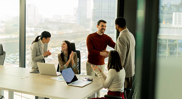 istock Team collaborates in modern office setting on innovative project with laptops and discussion 2217281148