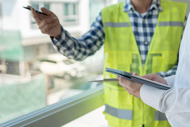 istock inspector engineer and owner project is inspecting construction and quality assurance new house. Engineers or architects or contactor work to build the house before handing it over to the homeowner 2217283095