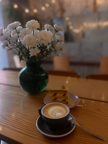 istock Coffee, cake, and flowers in a cozy cafe setting. 2217283828