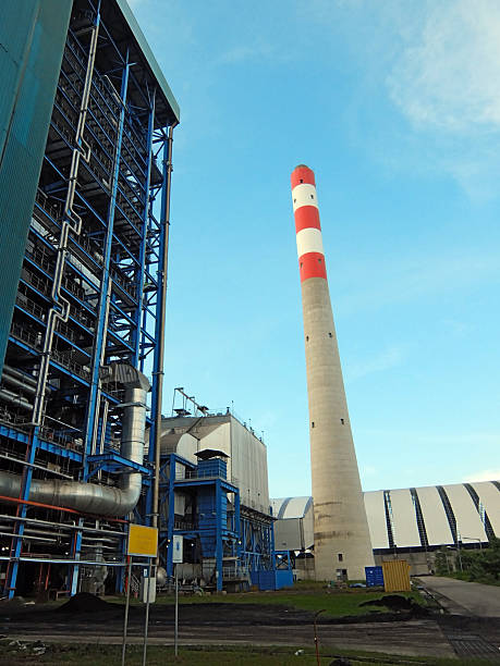 istock Vast industrial steam power plant with towering chimney and complex blue boiler structures. 2217285754