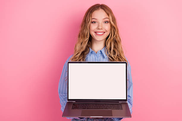 istock Charming young woman with laptop on pink background showcasing creativity in technology, education, and modern lifestyle 2217286900