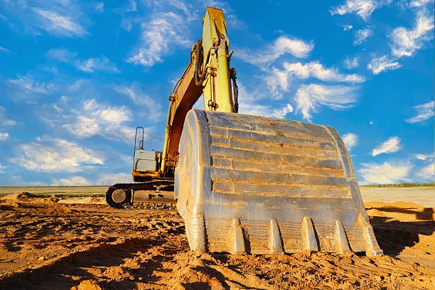 istock Excavator on earthmoving at construction site on blue sky. 2217287718