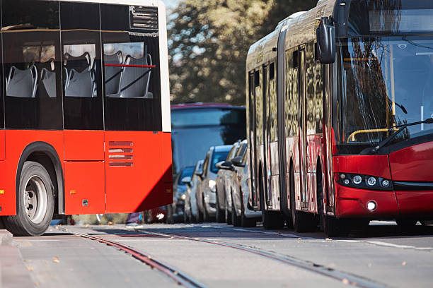 Red bus for public transportation on city streets.
