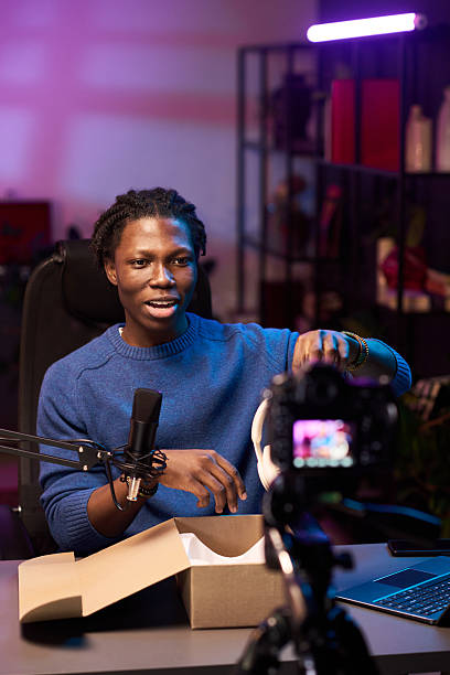 istock African American Vlogger Livestreaming on Camera at Desk 2217292530