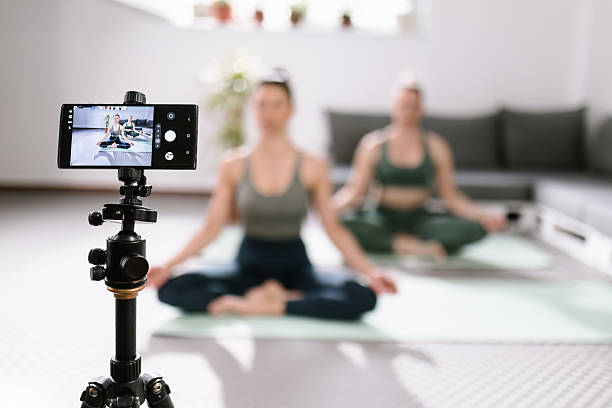 istock Two women practicing yoga at home while being recorded on a smartphone for online sharing during a peaceful session 2217294476