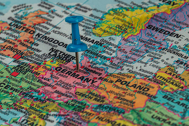 Red pushpin marking Poland on a world map, travel concept.