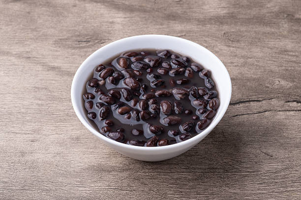 istock Cooked black beans in a bowl over wooden table 2217296615