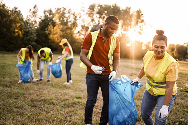 istock Volunteers collecting garbage in a public park during sunset 2217297093